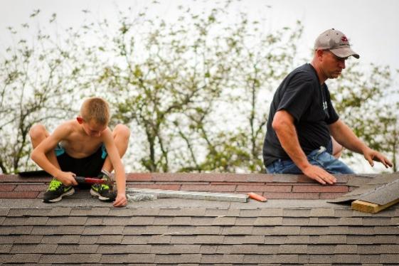 Father and son working on roof repair