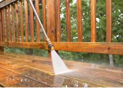 person cleaning a deck